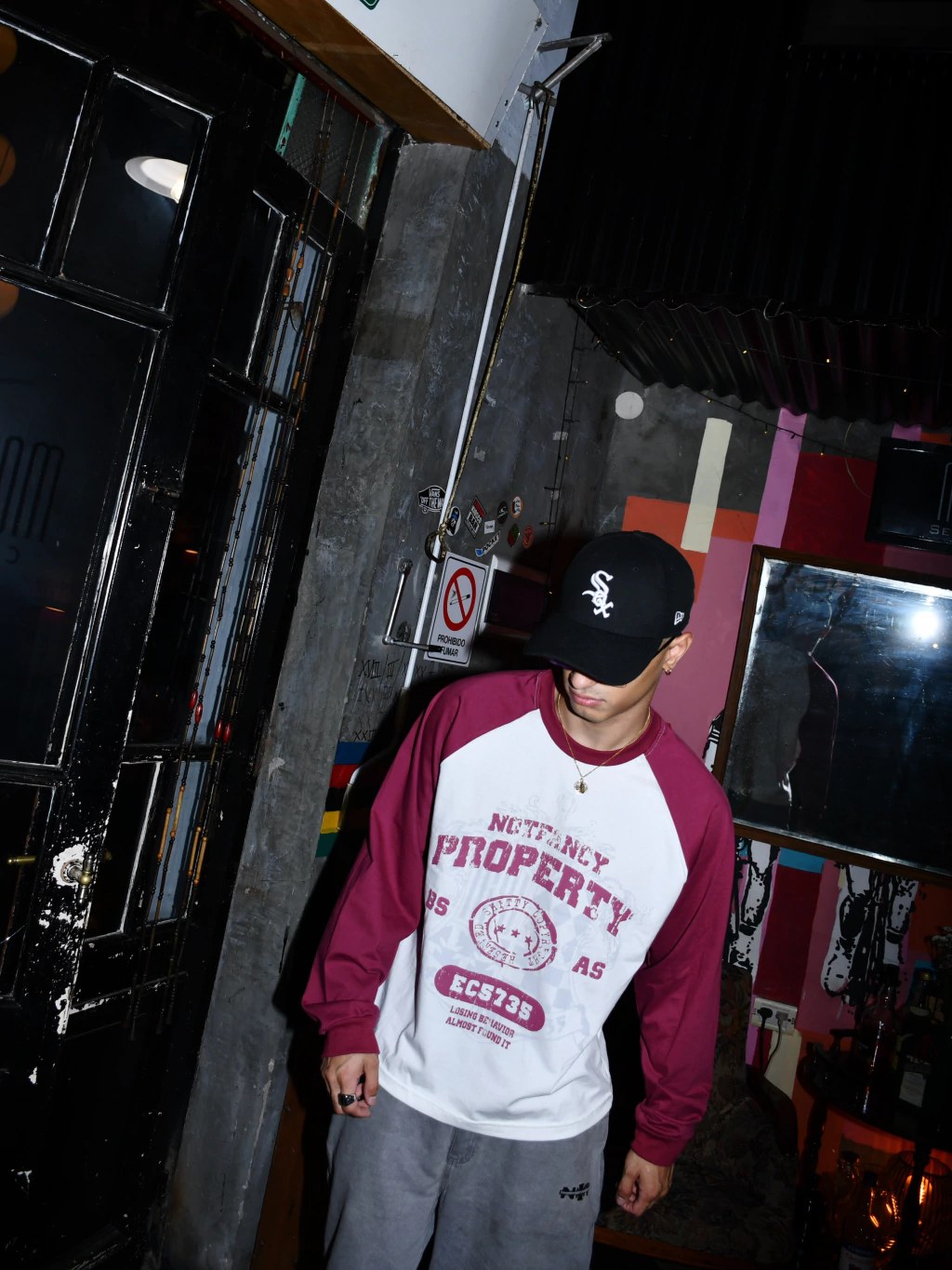 Modelo con gorra y la remera bordó y blanca